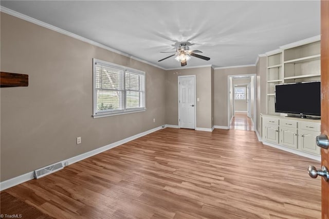 unfurnished living room with visible vents, light wood-style flooring, baseboards, ornamental molding, and a ceiling fan