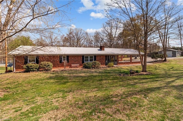 single story home with a chimney, brick siding, and a front yard