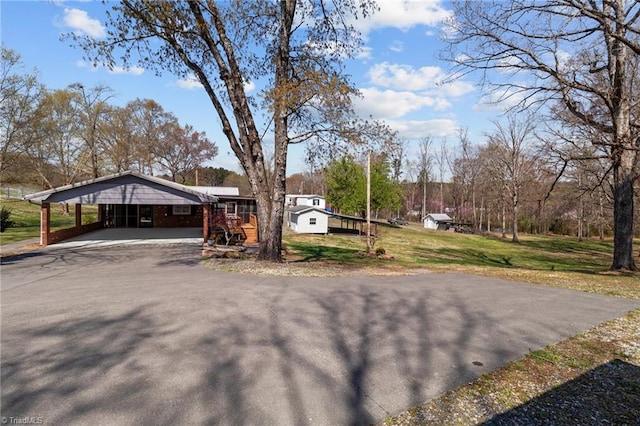 view of yard featuring driveway and an attached carport