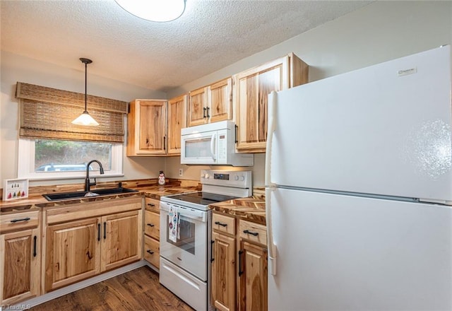 kitchen with white appliances, sink, hanging light fixtures, dark hardwood / wood-style floors, and a textured ceiling