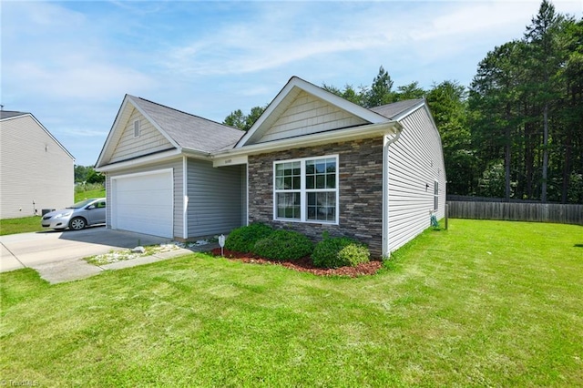 6605 Stickley Ct, Whitsett, NC 27377 - view of front of property with an attached garage, stone siding, and driveway