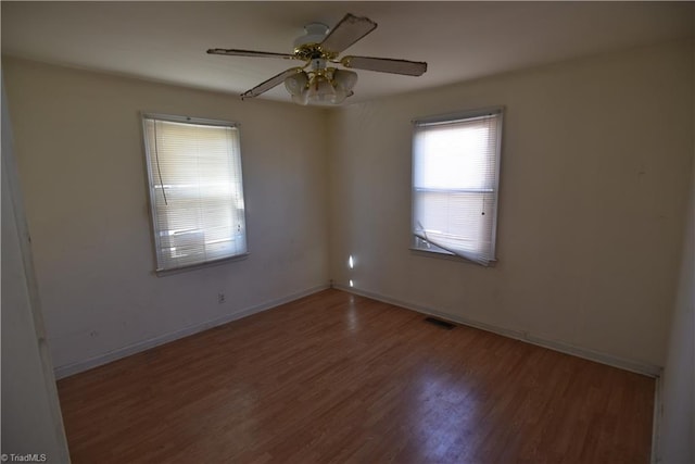 unfurnished room with ceiling fan and hardwood / wood-style flooring