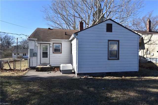 rear view of house featuring a yard