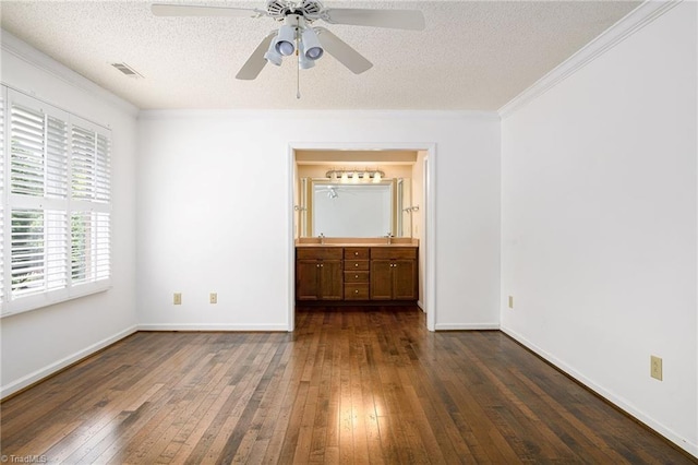 211 Chadbourne Dr, Winston-Salem, NC 27104 - unfurnished bedroom featuring dark wood-style flooring, ornamental molding, a textured ceiling, ensuite bath, and a ceiling fan