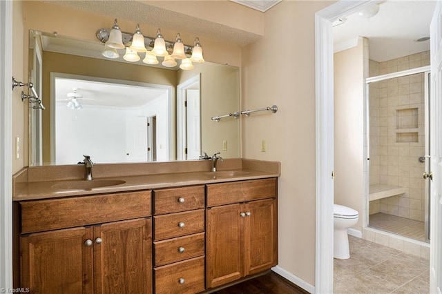 211 Chadbourne Dr, Winston-Salem, NC 27104 - bathroom featuring double vanity, a shower stall, crown molding, a ceiling fan, and tile patterned flooring