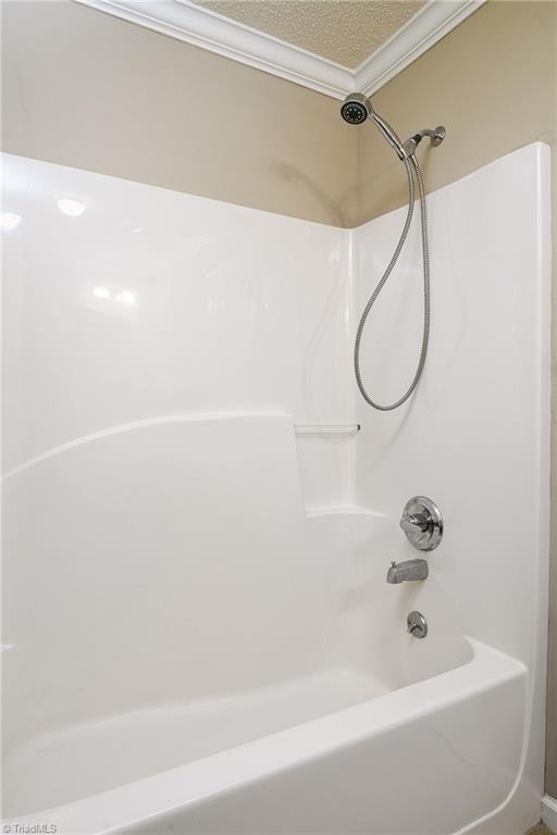 211 Chadbourne Dr, Winston-Salem, NC 27104 - bathroom with washtub / shower combination and ornamental molding