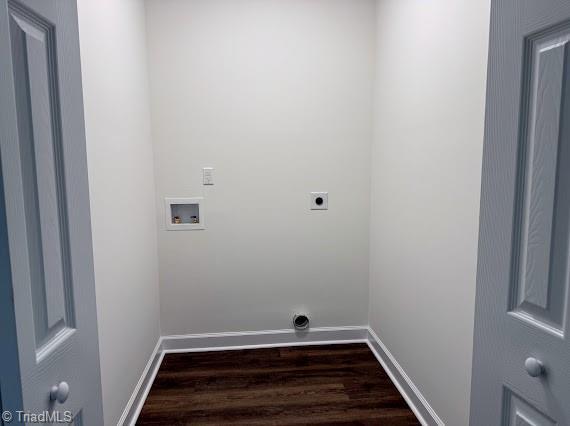 washroom with hookup for an electric dryer, washer hookup, dark wood-style flooring, and baseboards