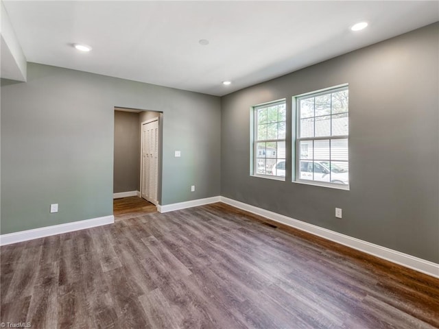 spare room featuring dark wood-type flooring