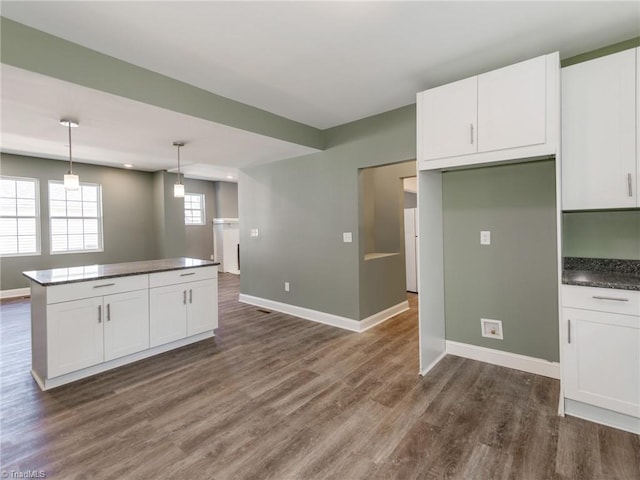 kitchen featuring hanging light fixtures, dark hardwood / wood-style flooring, and white cabinetry