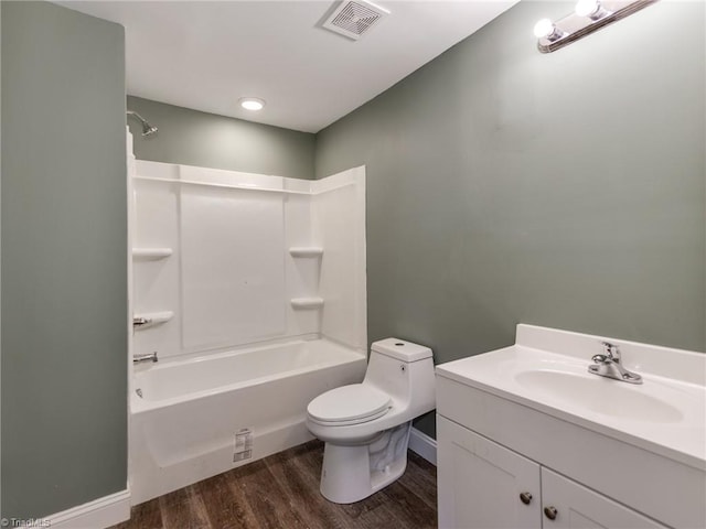 full bathroom with hardwood / wood-style flooring, shower / tub combination, vanity, and toilet