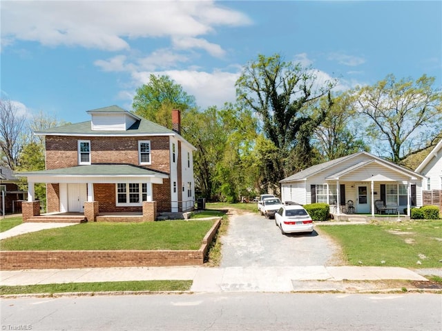 view of front of house with a front lawn and covered porch