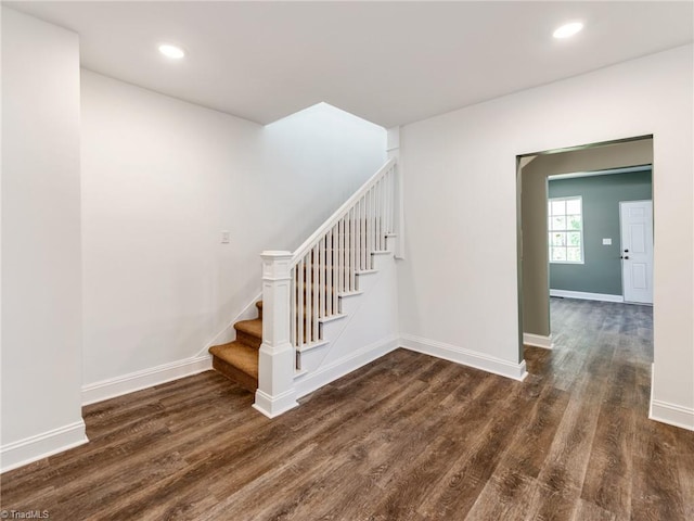 staircase with dark hardwood / wood-style flooring