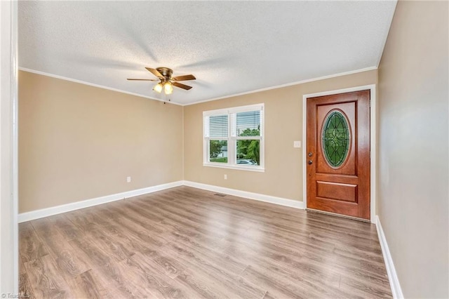 225 E Greencrest Dr, Millers Creek, NC 28651 - foyer with a ceiling fan, a textured ceiling, crown molding, wood finished floors, and baseboards