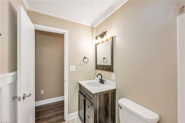 225 E Greencrest Dr, Millers Creek, NC 28651 - bathroom featuring vanity, a textured ceiling, toilet, crown molding, and wood finished floors