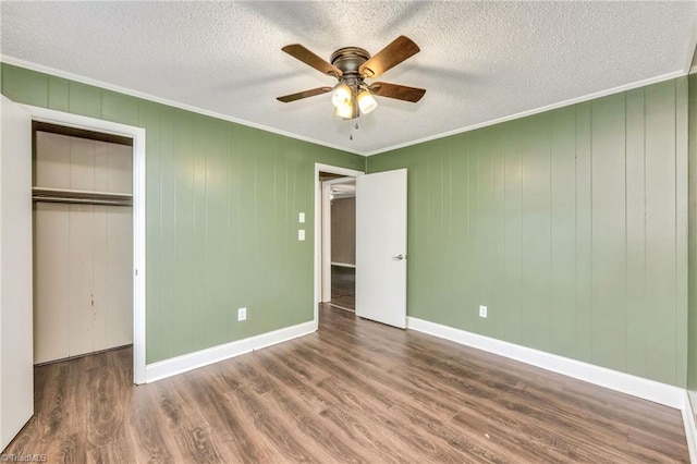 225 E Greencrest Dr, Millers Creek, NC 28651 - unfurnished bedroom with ornamental molding, wood finished floors, a closet, a textured ceiling, and ceiling fan