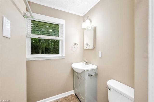 225 E Greencrest Dr, Millers Creek, NC 28651 - half bathroom with vanity, toilet, crown molding, and baseboards