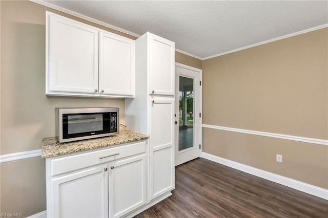 225 E Greencrest Dr, Millers Creek, NC 28651 - kitchen featuring white cabinetry, dark wood finished floors, baseboards, a textured ceiling, and ornamental molding