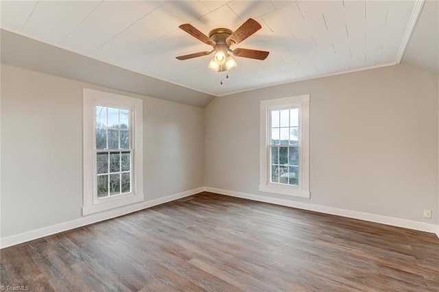 spare room featuring baseboards, wood finished floors, a ceiling fan, and lofted ceiling