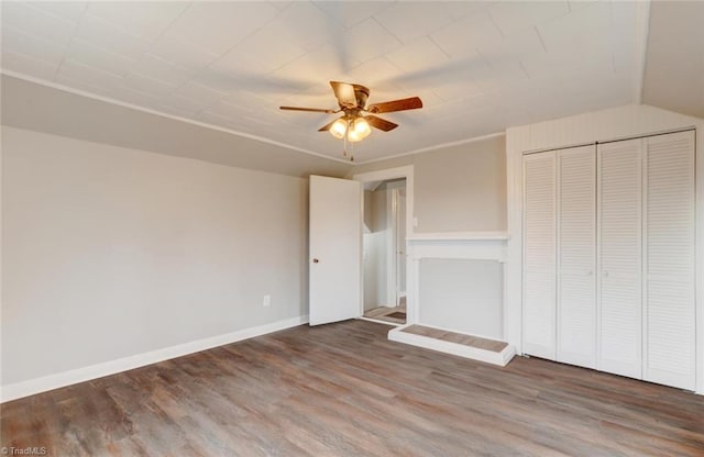 unfurnished living room with ceiling fan, wood finished floors, and baseboards