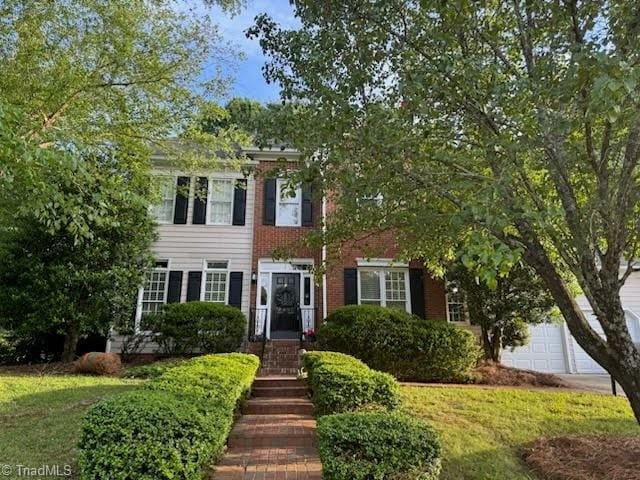 2901 Peninsula Dr, Jamestown, NC 27282 - view of front of property with a front lawn and a garage