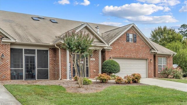 view of front of house with a front yard and a garage