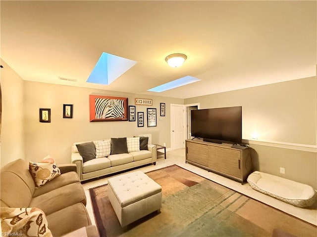 carpeted living area featuring visible vents and a skylight