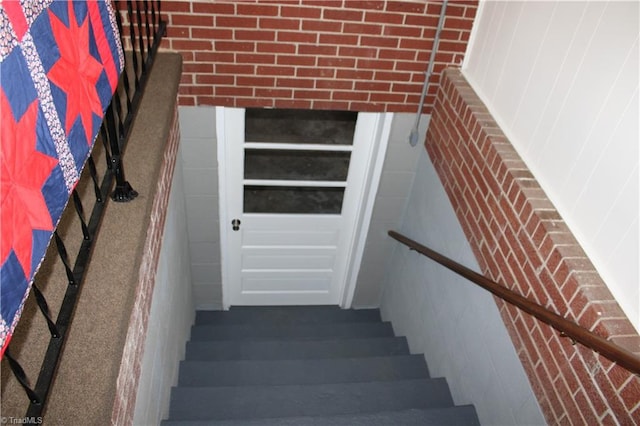 staircase with brick wall