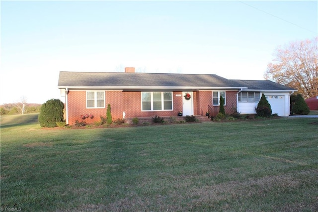 ranch-style home with a front yard and a garage