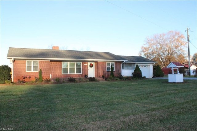 ranch-style home with a front yard and a garage