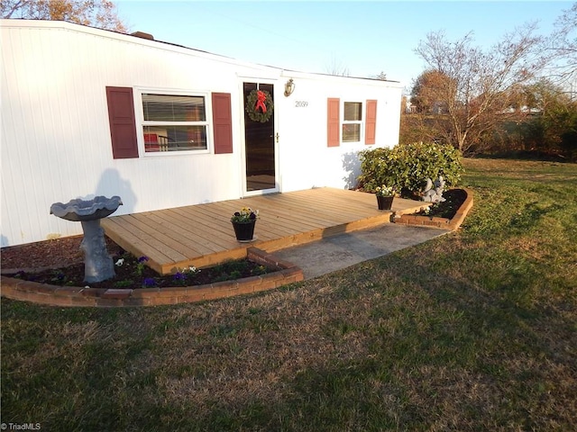 view of front of home featuring a front yard and a deck