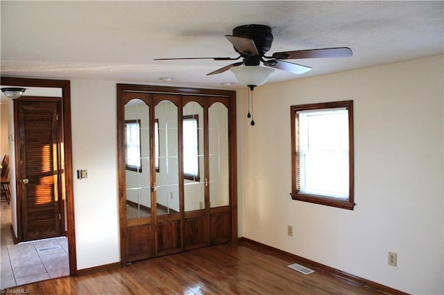 entrance foyer featuring ceiling fan and wood-type flooring