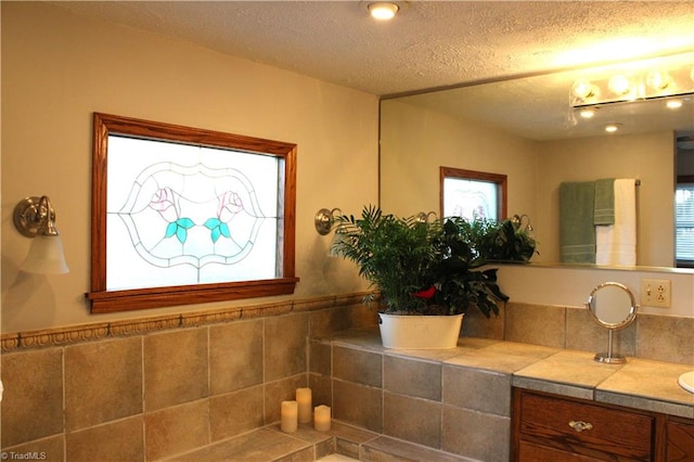 bathroom with vanity and a textured ceiling