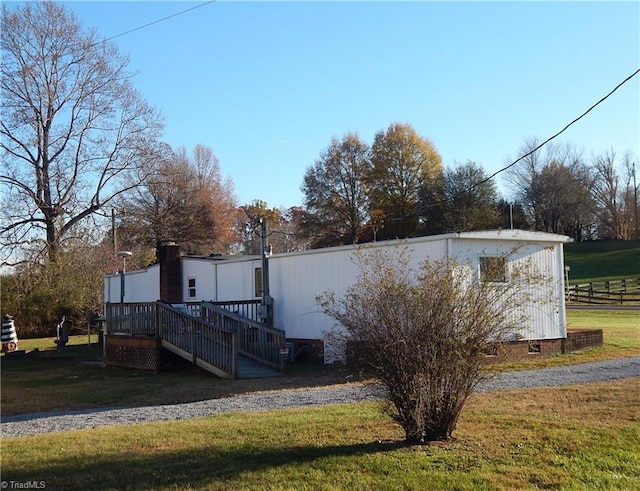 exterior space with a lawn and a wooden deck