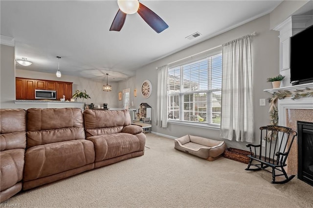 183 Kentland Ridge Dr, Kernersville, NC 27284 - living room featuring carpet flooring, a glass covered fireplace, a ceiling fan, and baseboards