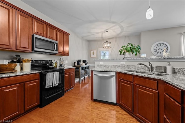 183 Kentland Ridge Dr, Kernersville, NC 27284 - kitchen with stainless steel appliances, a sink, light wood-type flooring, decorative light fixtures, and light stone countertops