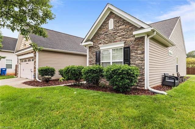 183 Kentland Ridge Dr, Kernersville, NC 27284 - view of front of home featuring stone siding, a front lawn, concrete driveway, roof with shingles, and a garage