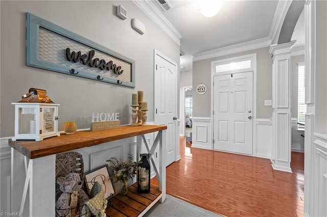 183 Kentland Ridge Dr, Kernersville, NC 27284 - foyer entrance with ornate columns, crown molding, wood finished floors, wainscoting, and a decorative wall