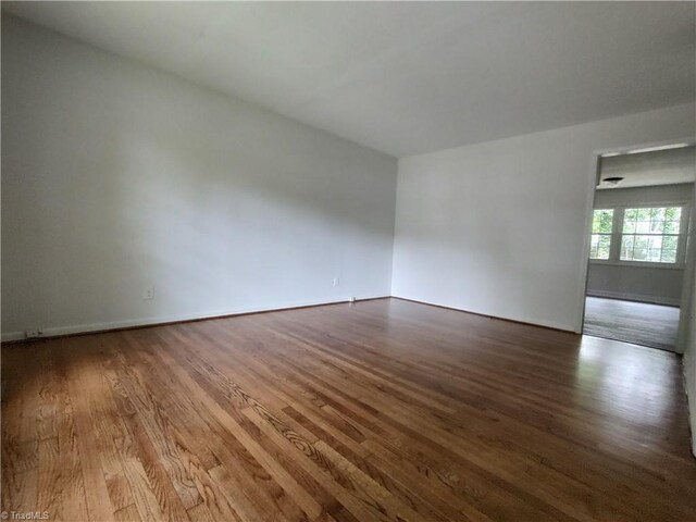 unfurnished room featuring wood-type flooring