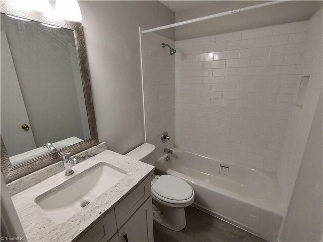 full bathroom with tiled shower / bath, vanity, and toilet