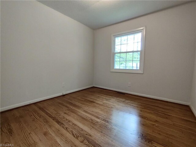 unfurnished room featuring light hardwood / wood-style flooring