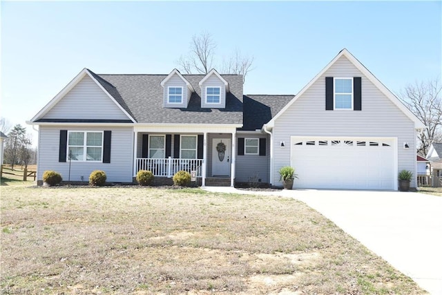 cape cod house with roof with shingles, a porch, concrete driveway, and a front yard