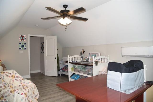 bedroom with a ceiling fan, wood finished floors, baseboards, a wall mounted AC, and lofted ceiling