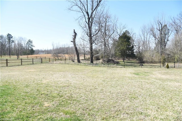 view of yard featuring a rural view and fence