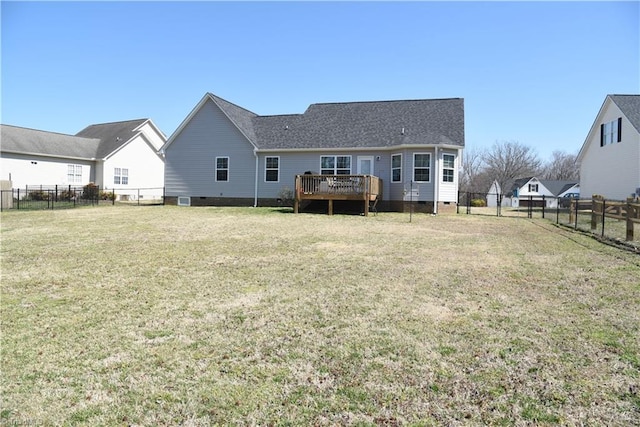 back of property with a yard, a fenced backyard, a shingled roof, crawl space, and a deck