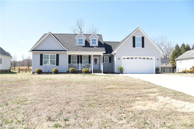 cape cod house with a porch, concrete driveway, a front yard, and fence