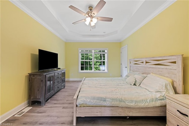 5360 Graycliff Ln, Clemmons, NC 27012 - bedroom featuring a tray ceiling, wood finished floors, ornamental molding, and ceiling fan