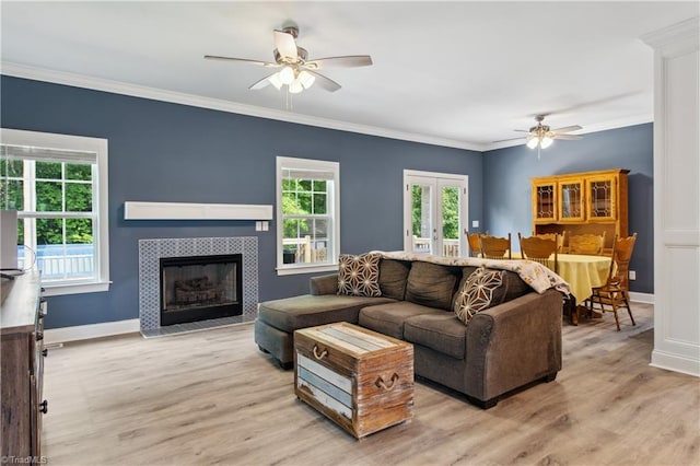 5360 Graycliff Ln, Clemmons, NC 27012 - living room featuring a ceiling fan, light wood-style flooring, a fireplace, and crown molding