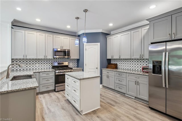 5360 Graycliff Ln, Clemmons, NC 27012 - kitchen featuring stainless steel appliances, crown molding, decorative backsplash, light stone counters, and light wood-style floors