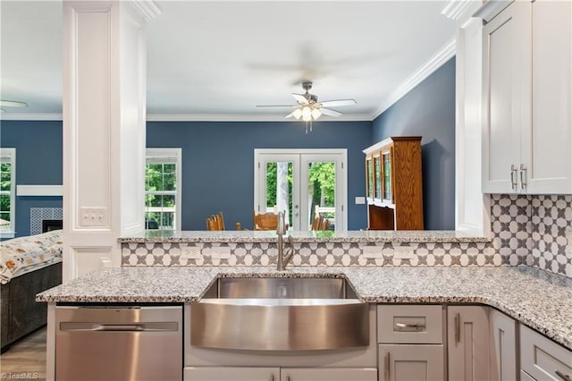 5360 Graycliff Ln, Clemmons, NC 27012 - kitchen with stainless steel dishwasher, ceiling fan, decorative backsplash, light stone counters, and ornamental molding