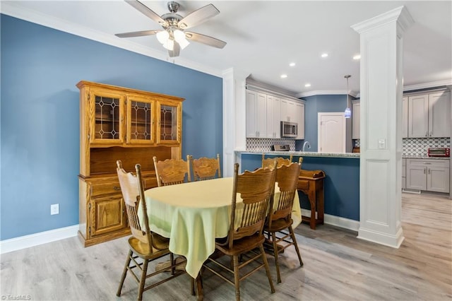 5360 Graycliff Ln, Clemmons, NC 27012 - dining space with ornamental molding, light wood finished floors, a ceiling fan, recessed lighting, and ornate columns